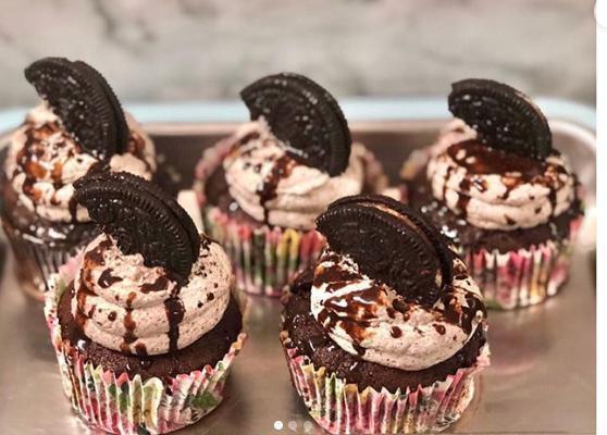 Oreo Cream Chocolate Cupcake · Chocolate cupcake with an oreo cream center topped with chocolate drizzle and oreo cookie.