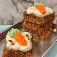 Carrot Cake · Carrot cake slice with walnuts and cream cheese icing.