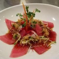 Carpaccio · 7pc Sashimi in seafood and ponzu sauce with onion sprouts