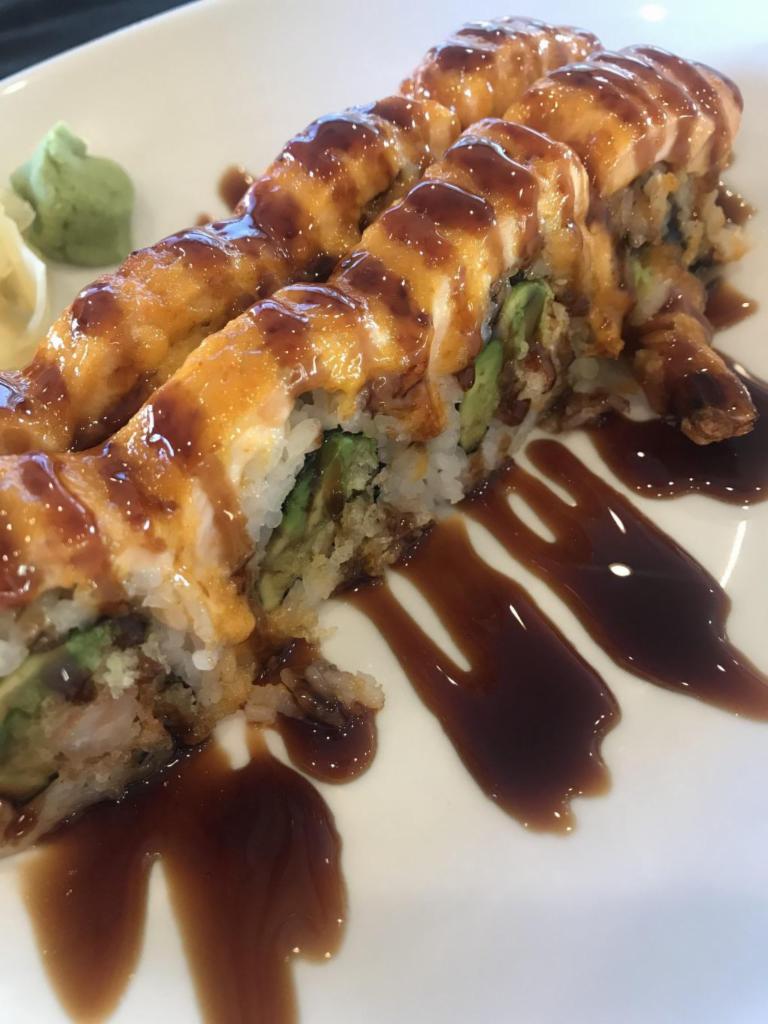 Salmon Heights Roll · Baked. In: shrimp tempura, avocado, crunchy flour. 
Out: salmon baked with spicy mayo, eel sauce.