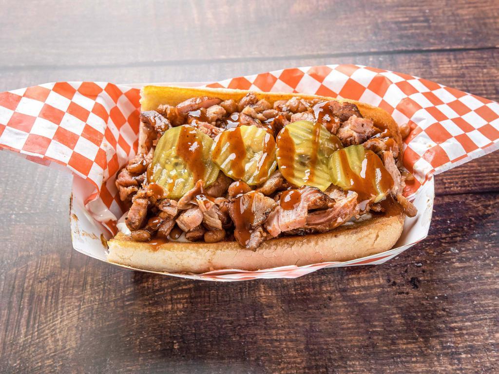Rib Sandwich · Our chopped rib sandwich comes with our delicious ribs mixed with our bushes baked beans. Topped with pickles and our sweet BBQ sauce.