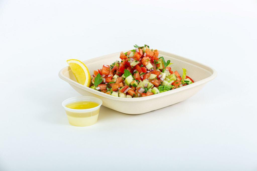 Israeli chopped salad · Tomatoes, cucumbers, red onions and herbs with lemon juice, olive oil and tahini sauce