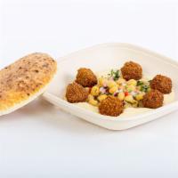 Hummus with falafel balls · Crispy falafel balls, tahini sauce, and herbed chickpea mix