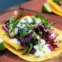 Hibiscus Flower Tacos · Award winning* Caramelized hibiscus flowers and onions, 
cabbage, avocado mousse, cilantro, ...