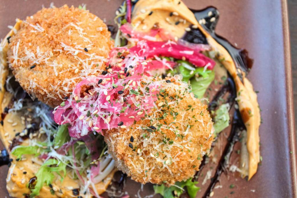 Furikake Crab Cakes · Rice panko jackfruit, macha furikake aioli, sesame seeds, pickle onions and micro salad. Contains 2 pieces. Gluten free, soy free, and nut free. Add cake for an additional charge.