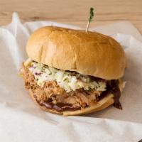 Pulled Pork BBQ Sandwich · Marinated pulled pork cooked in special BBQ sauce topped with coleslaw. Comes with potato ch...