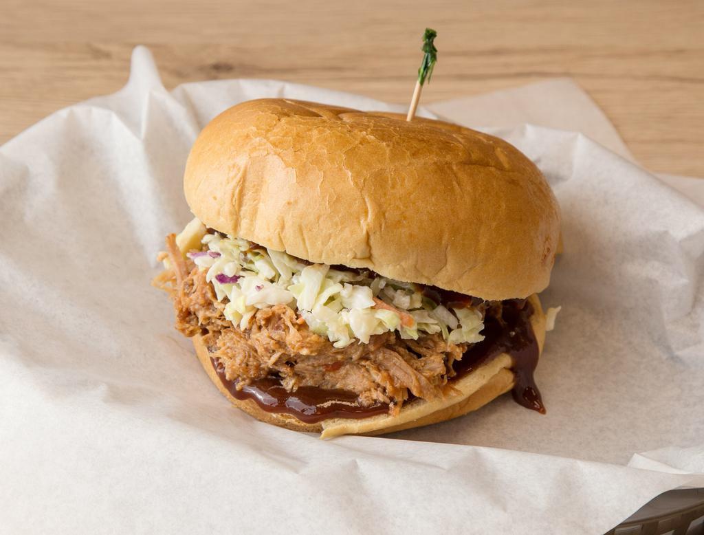 Pulled Pork BBQ Sandwich · Marinated pulled pork cooked in special BBQ sauce topped with coleslaw. Comes with potato chips.
