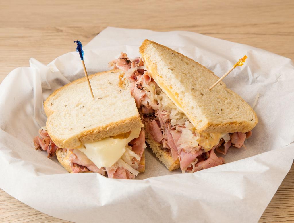 The Reuben Sandwich · Pastrami, sauerkraut, melted Swiss and Thousand Island sauce. Comes with potato chips.