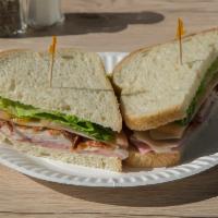 Super Club · Turkey breast, ham, bacon, Swiss, lettuce, tomatoes and our special sauce. Comes with potato...