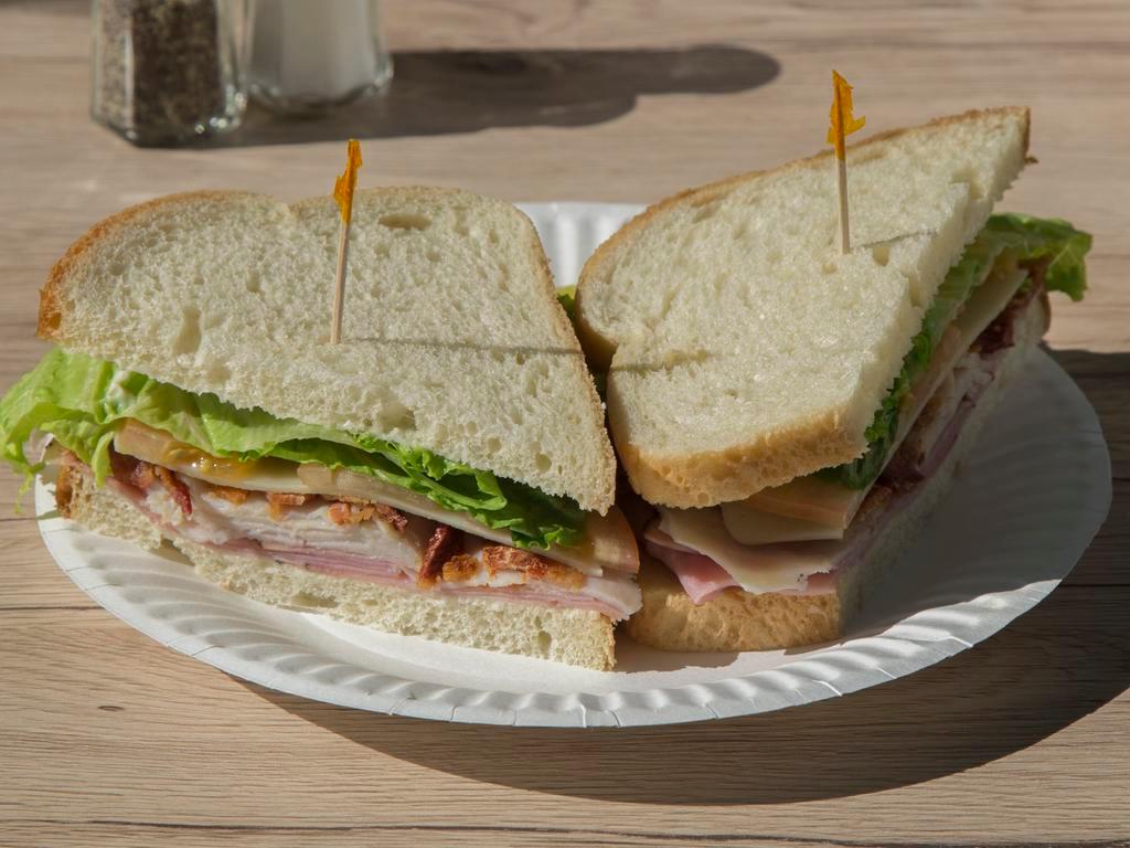 Super Club · Turkey breast, ham, bacon, Swiss, lettuce, tomatoes and our special sauce. Comes with potato chips.