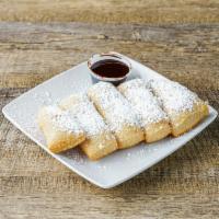 Fried Dough Zeppolis · Covered with powdered sugar.