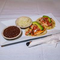 Tacos de Salmon · 2 soft corn tortillas topped with grilled salmon, marinated cabbage, pico de gallo, and avoc...
