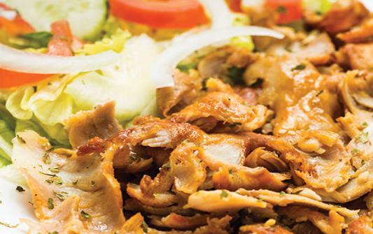 Chicken shawarma  · Roasted thin slices of marinated Chicken with hummus tahini, garlic, salad rice & pita bread. 
