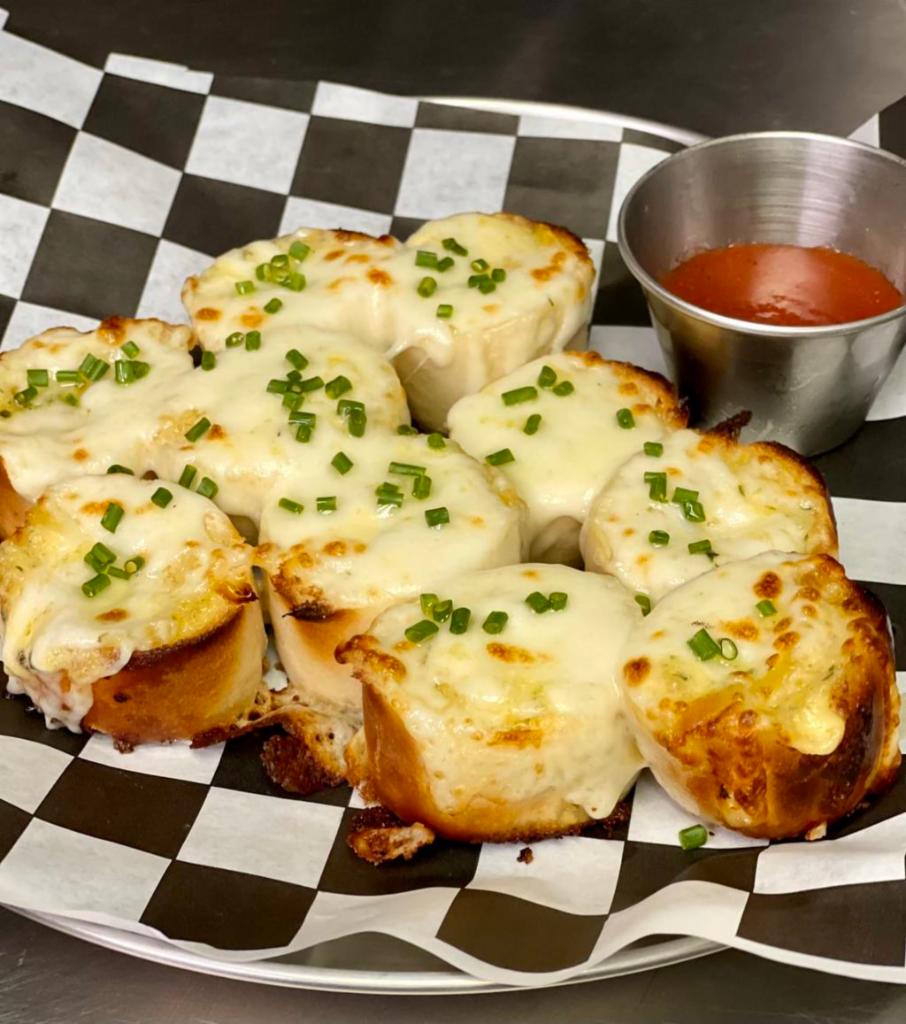 Garlic Bread - 10 pieces · Garlic bread with mozzarella cheese, fresh chives and tomato sauce on the side.