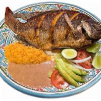 Mojarra · Tilapia fish are cooked fried in oil spicy sal and pepper, garnishes such as rice, beans, le...