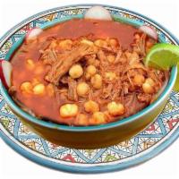 Posole Soup · Hominy soup. Boiled with pork meat and red sauce garnishes such as onion, cilantro, arbol pe...