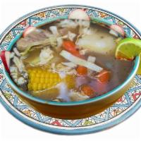 Caldo de Res · Beef soup. Boiled with potato, carrots, corn, garnishes such as onion, cilantro, lime, rice.