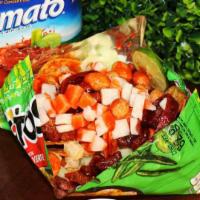 Tostibomba Tostitos · Rielito, peanuts, serpentina, cucumber, jicama, lime, chamoy, and clamato over tostito chips.