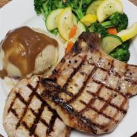 Grilled Pork Chops · 2 seasoned and grilled 8oz centercut pork chops served with mashed potatoes and mixed vegeta...
