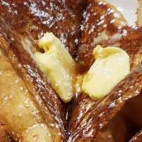 French Toast · Made with fresh baked challa bread served with butter and syrup.