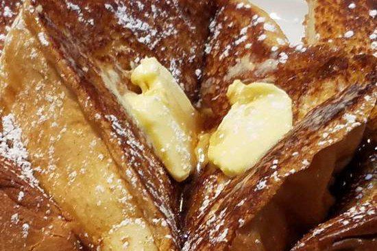 French Toast · Made with fresh baked challa bread served with butter and syrup.
