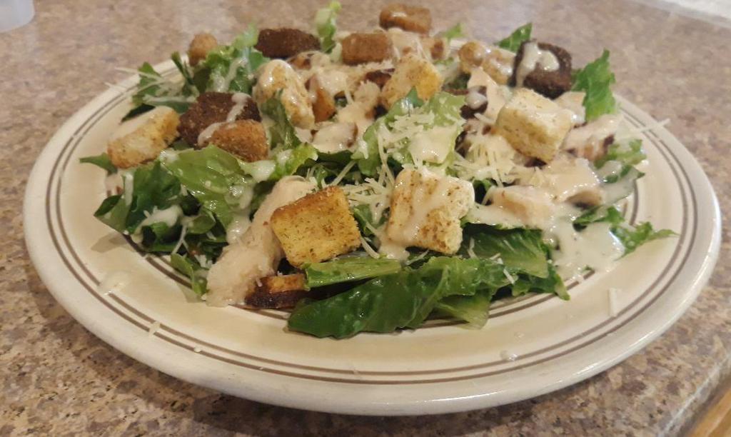 Grilled Chicken Caesar Salad · Chicken, Parmesan cheese, croutons, with Caesar dressing.
