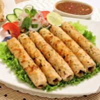 Chicken Seekh Kabab · Minced chicken marinared with herbs and spices cooked in a clay oven.