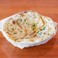 Garlic Naan  · Bread topped with garlic and baked in tandoor clay oven.