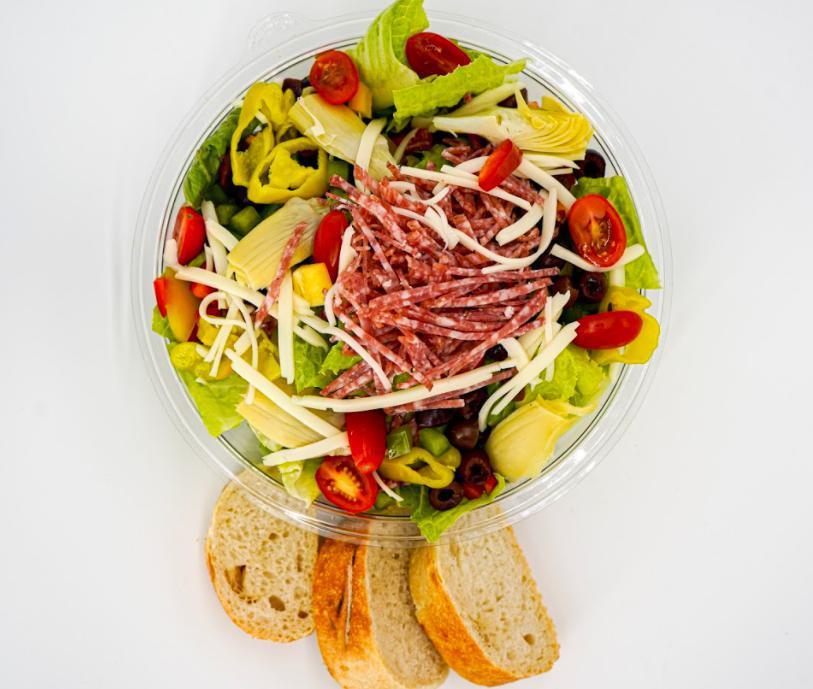 Italian Salad · Chopped romaine, red peppers, salami, mozzarella, Kalamata olives, tomatoes, artichoke hearts, pepperoncinis, Italian dressing, served with sourdough bread.