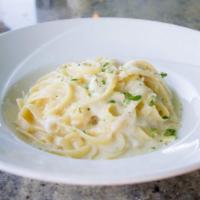 Fettuccine Alfredo · Fettuccine tossed in a creamy Parmesan garlic sauce with a touch of wine. Garnished with par...