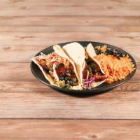 2 BBQ Pork Tacos · Braised in house pork smothered in BBQ sauce, cabbage, corn salsa, mixed cheese and flour to...