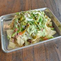 Nachos · Choice of meat topped with shredded lettuce, diced tomatoes, melted cheese, pickled jalapeno...