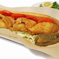 Crispy Golden Catfish Po'boy · Crispy fried catfish settled into a toasted french bread served with lettuce, tomatoes, Creo...