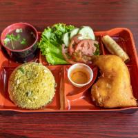 Crispy Chicken Fried Rice · Marinated, flash-fried chicken served with fried rice, lettuce, tomato, cucumbers, and a sma...