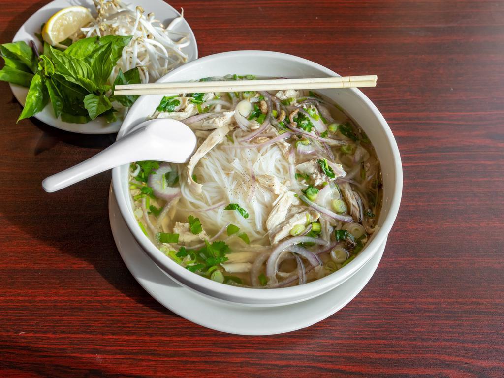 Vietnamese Chicken Noodle Soup · Soft rice noodles in a slow-simmered, aromatic bone broth, served with sliced chicken and fresh herbs and vegetables for topping.