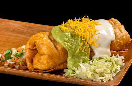Chimichanga · Shredded beef or chicken burrito, deep fried, and topped with guacamole, sour cream, cheese, pico de gallo, and lettuce.
