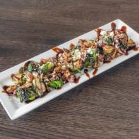 Braised Brussel Sprouts · Crisp Brussels sprouts tossed with a citrus vinaigrette and topped with bacon, candied walnu...