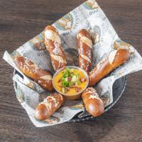 Warm Pretzel Sticks · Served with jalapeno cheddar and bacon sauce topped with scallions.