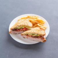Range Cafe Club Sandwich · Roasted turkey breast, sliced ham, applewood bacon, tomatoes, green leaf lettuce, lemon Ailo...