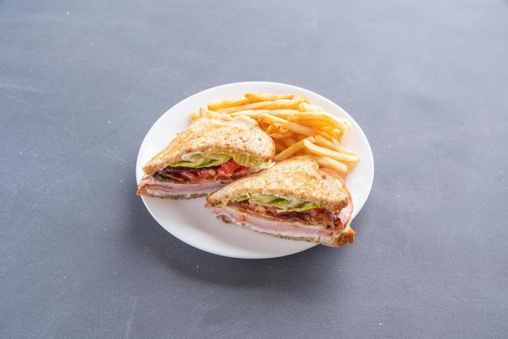 Range Cafe Club Sandwich · Roasted turkey breast, sliced ham, applewood bacon, tomatoes, green leaf lettuce, lemon Ailoi, with thin-cut fries or mixed greens.