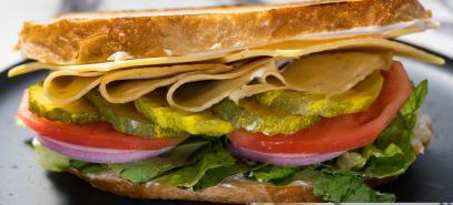 Big Thinker · Herbivorous butcher turkey slices, smoked gouda cheese, raw onions, pickles, tomatoes, and l...