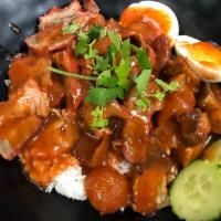 Kao Moo Dang · Roasted pork, crispy pork and thai pork sausage with red B.B.Q. sauce on rice.*Contain Peanut.