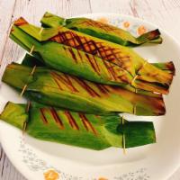 Grilled sweet Sticky-rice with Banana · Banana Leave wrapped sweet coconut stick rice filling with sweet Banana