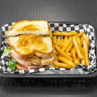 Turkey Club Sandwich-Triple Decker · Includes mayo, lettuce and tomatoes. Served with fries.