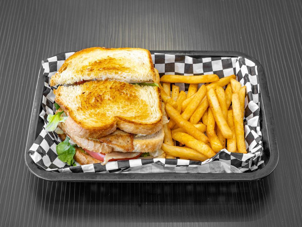 Turkey Club Sandwich-Triple Decker · Includes mayo, lettuce and tomatoes. Served with fries.
