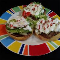 1 Sopes de Pollo · Sope with beans, chicken, lettuce, tomato, sour cream and cheese.