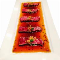 Filet Mignon Carpaccio · Thin sliced filet mignon served with fried ginger and yuzu sauce.