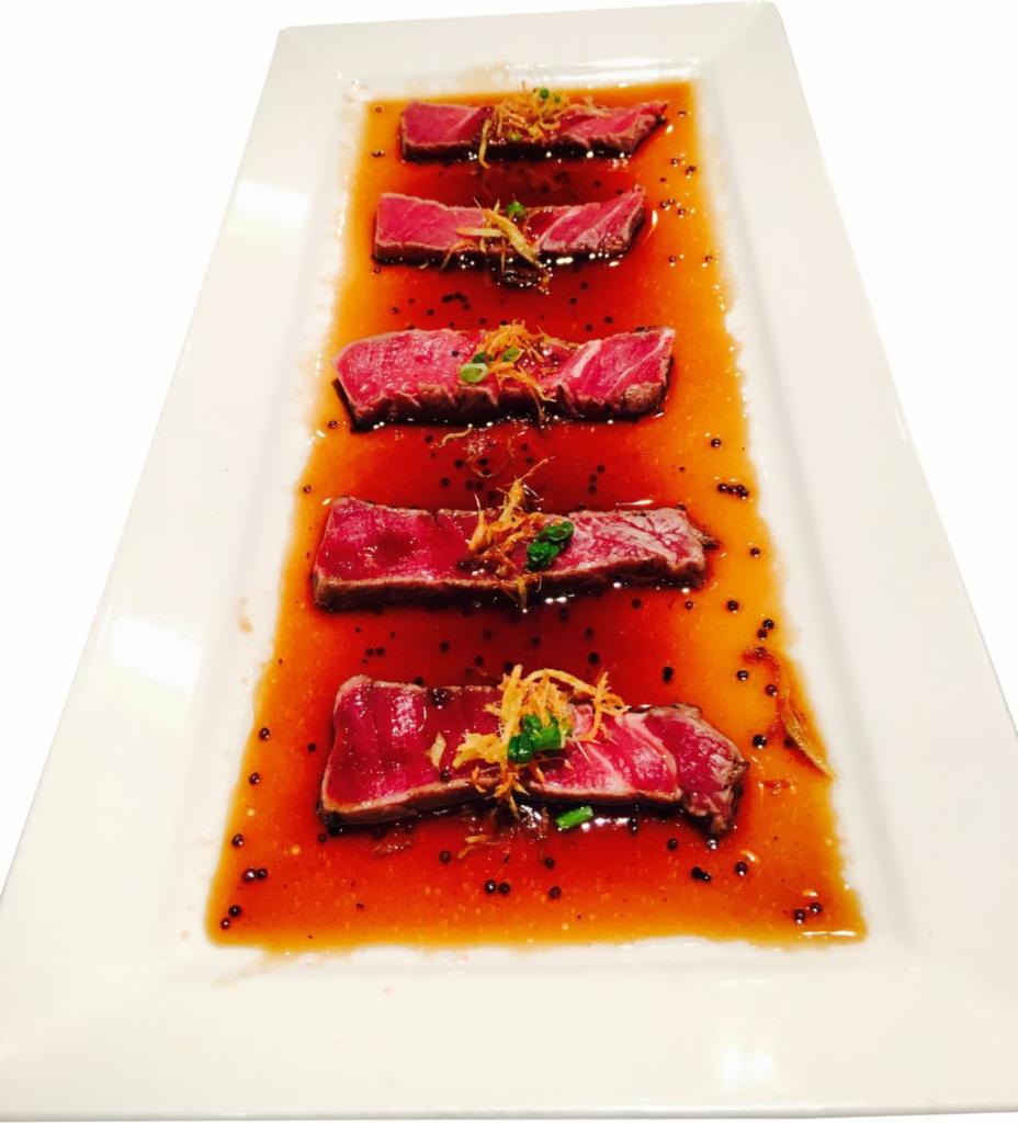 Filet Mignon Carpaccio · Thin sliced filet mignon served with fried ginger and yuzu sauce.