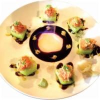 Volcano Roll · Shrimp tempura, cucumber and avocado wrapped in green soy paper topped with spicy crunchy tu...