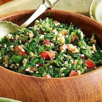 Tabouli Salad · Bowl of finely chopped flat-leaf parsley, fine bulgur, fresh mint, onion, red and black pepp...